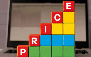 Building blocks in Microsoft colours stacked in increasing heights to represent the Microsoft 356 price increases.